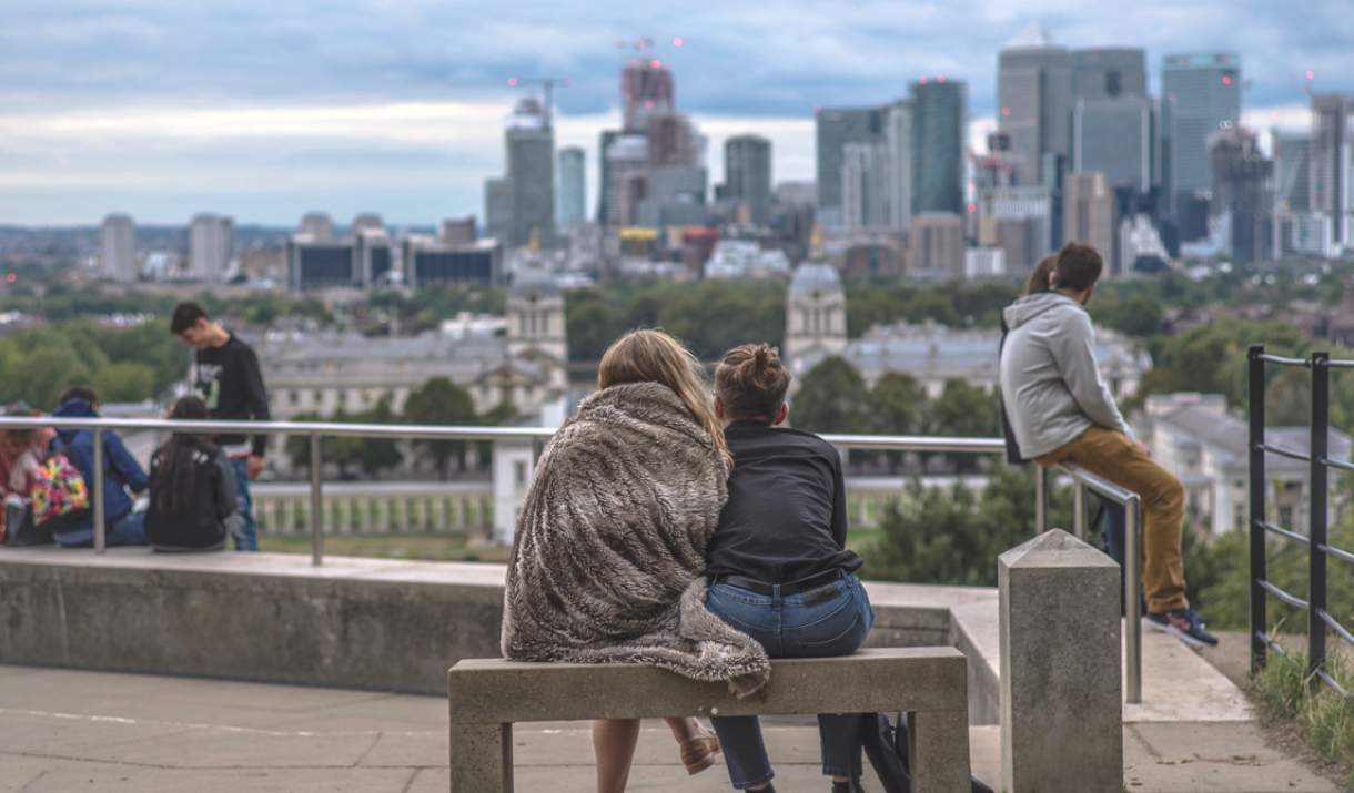 Couple wrapped in a blanket looking over the views of Greenwich.